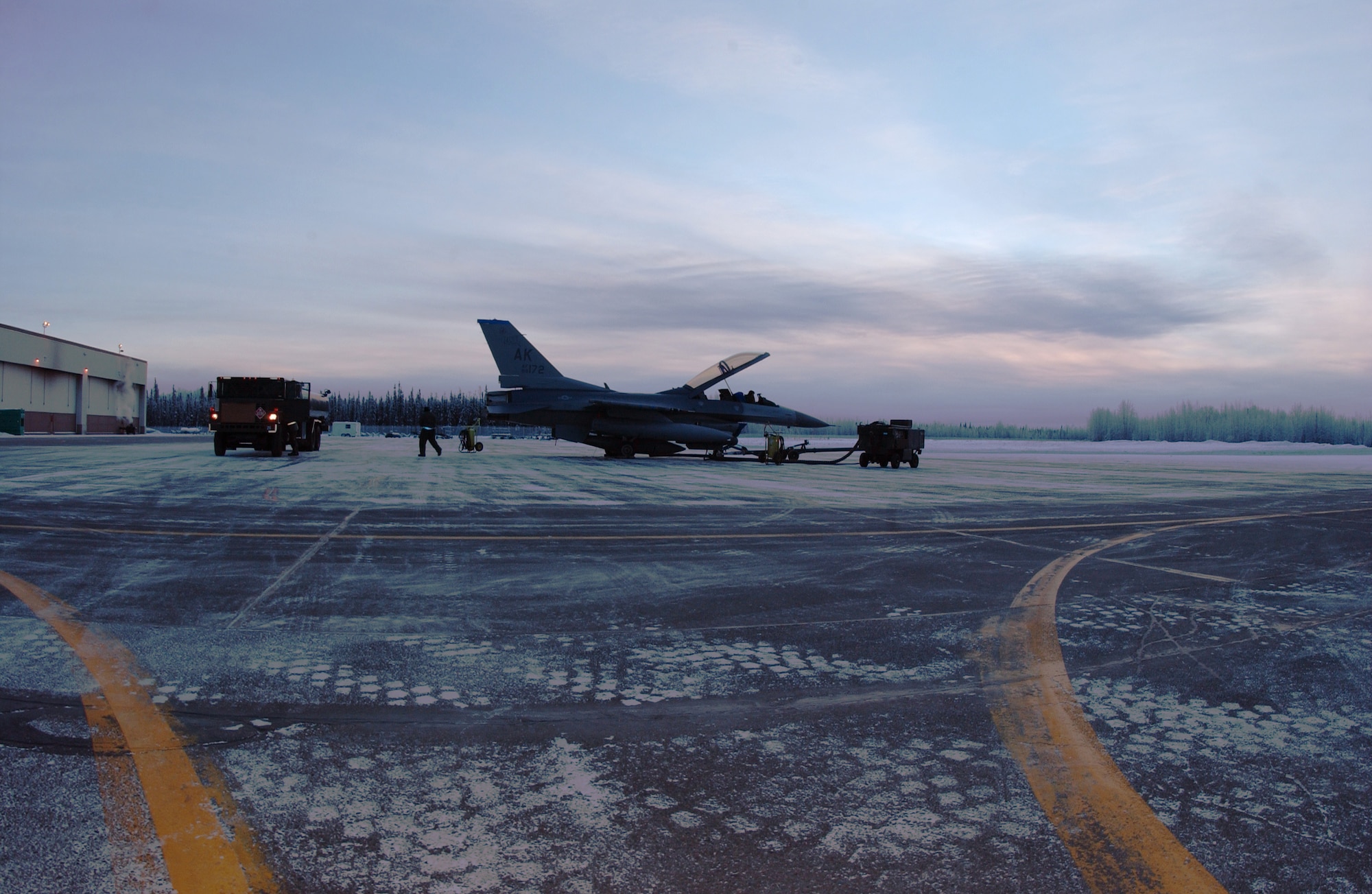 EIELSON AIR FORCE BASE, Alaska -- Icemen of the 354 Maintenance Squadron de-fuels an F-16 Fighting Falcon on the Flight Line, Dec. 21. Today is Winter Solstice, the shortest day of the year. At Eielson Air Force Base the sun rose at 1052 and set at 1441 today resulting in a total of 3 hours and 49 minutes from sun up to sun down. This night will be extra dark due to the moon being completely below the horizon all day resulting in 0% moonlight illumination.
(U.S. Air Force Photo by Airman Jonathan Snyder)