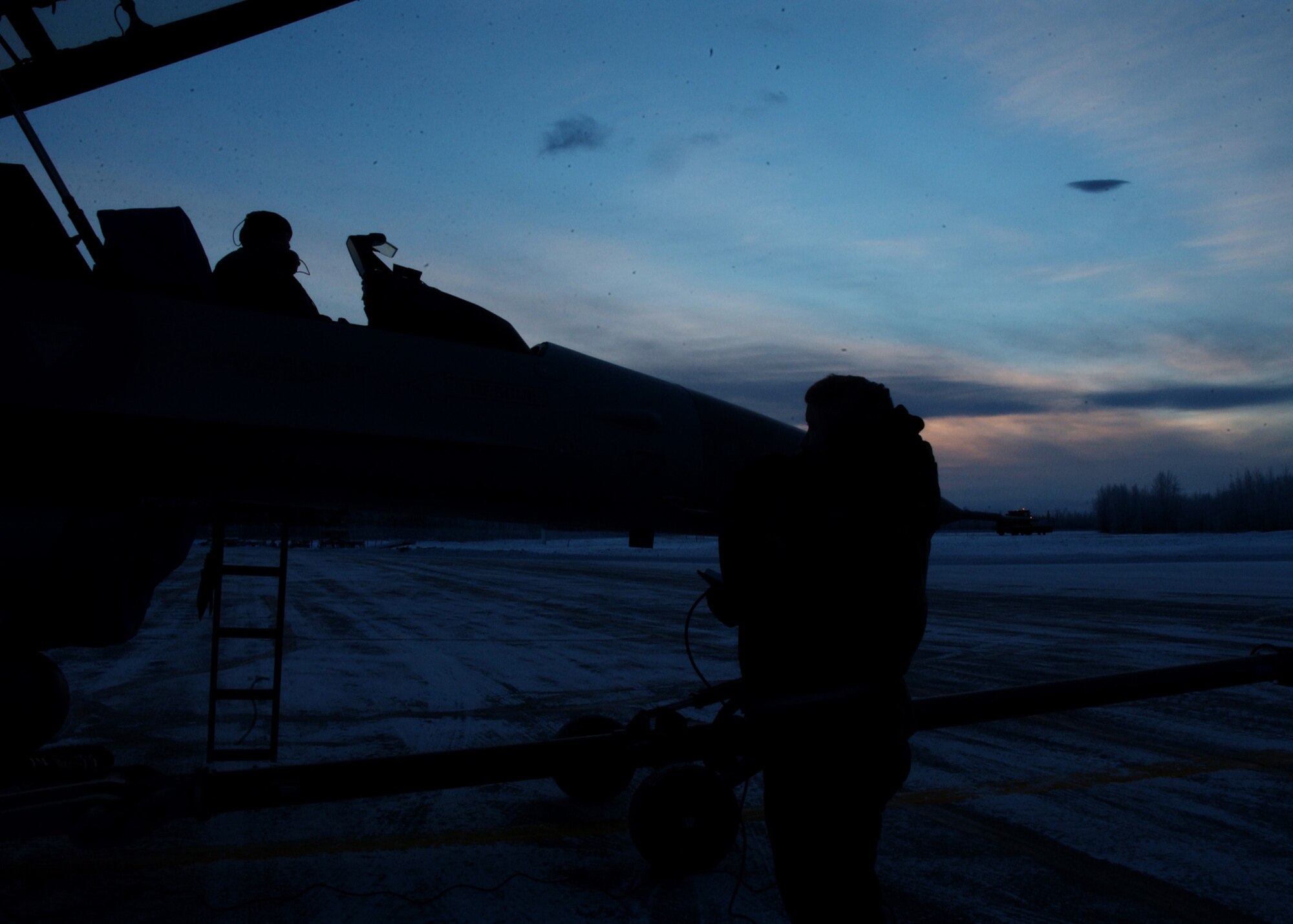 EIELSON AIR FORCE BASE, Alaska -- Staff Sgt. John Eby and Technical Sgt. Eldon Arnaud (sitting in the cockpit), 354 Aircraft Maintenance Squadron, de-fuel an F-16 Fighting Falcon on the Flight Line, Dec. 21. Today is Winter Solstice, the shortest day of the year. At Eielson Air Force Base the sun rose at 1052 and set at 1441 today resulting in a total of 3 hours and 49 minutes from sun up to sun down. This night will be extra dark due to the moon being completely below the horizon all day resulting in 0% moonlight illumination. 
(U.S. Air Force Photo by Airman Jonathan Snyder)