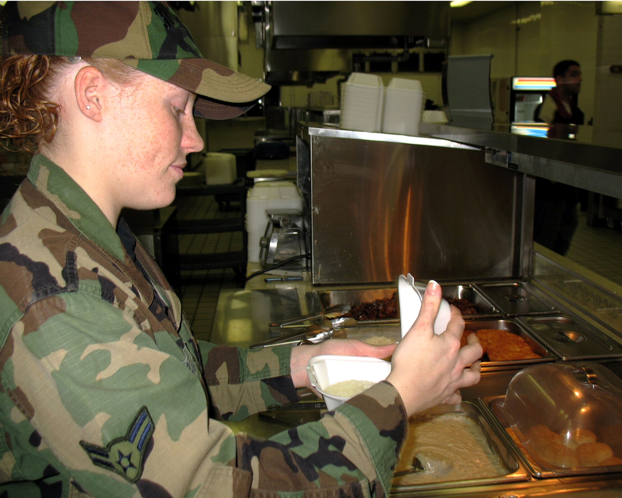 Airman 1st Class Christina Grable is celebrating her Christmas by cooking at the Samurai Cafe at Yokota Air Base, Japan. (U.S. Navy photo/MC3 Jason Segedy)
