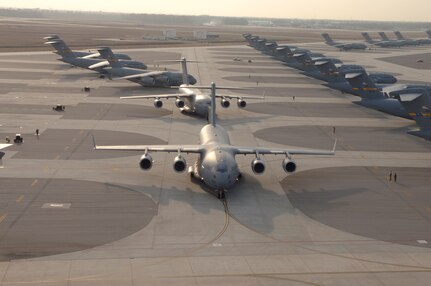 Twenty C-17 Globemaster III's prepare to take-off, Dec. 21, 2006. Charleston Air Force Base, S.C., launched a record-breaking formation of C-17 aircraft; the largest formation of C-17's to take flight from a single base.  Aircrews consisting of active-duty Airmen from the 437th Airlift Wing and reservists from the 315th Airlift Wing participated in the mission, which included airdrops over North Auxiliary Airfield in Orangeburg, S.C., aerial refueling and low level tactical training. (U.S. Air Force photo by Staff Sgt. April Quintanilla)
