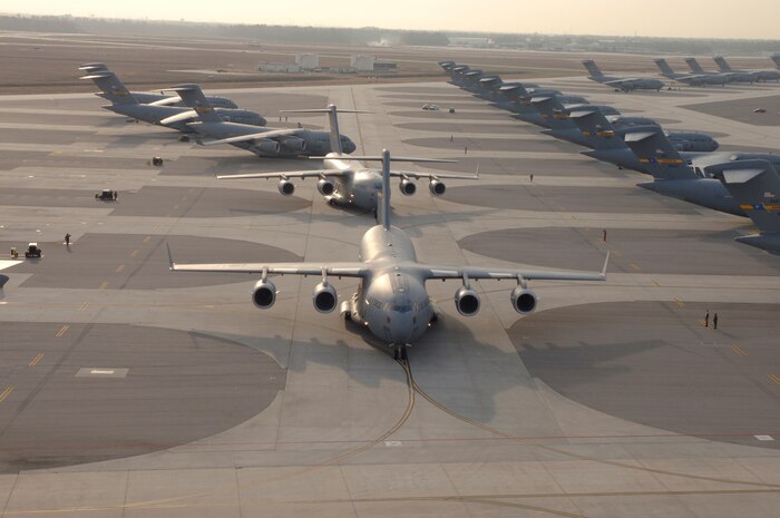 Twenty C-17 Globemaster III's prepare to take-off, Dec. 21, 2006. Charleston Air Force Base, S.C., launched a record-breaking formation of C-17 aircraft; the largest formation of C-17's to take flight from a single base.  Aircrews consisting of active-duty Airmen from the 437th Airlift Wing and reservists from the 315th Airlift Wing participated in the mission, which included airdrops over North Auxiliary Airfield in Orangeburg, S.C., aerial refueling and low level tactical training. (U.S. Air Force photo by Staff Sgt. April Quintanilla)
