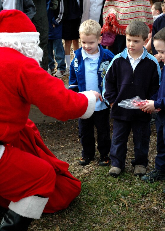 Santa talks with students from Crestview Elementary School on Vandenberg Air Force Base, Calif., about their Christmas wishes.  Santa came to the school on a 76th Helicopter Squadron UH-1N Huey to present student representatives with bags of candy canes for their classrooms.  (U.S. Air Force photo by Staff Sgt. Raymond Hoy)