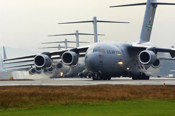 Several C-17 Globemaster III's sit on the flightline prior to being cleared for takeoff as part of a formation training exercise Dec. 20 from McChord Air Force Base, Wash.  The exercise consisted of 10 aircraft and was designed to test all the organizations and different aspects of the mission that have to come together to facilitate launching, executing and recovering a large formation of C-17's in a short period of time. (U.S. Air Force photo/Abner Guzman)