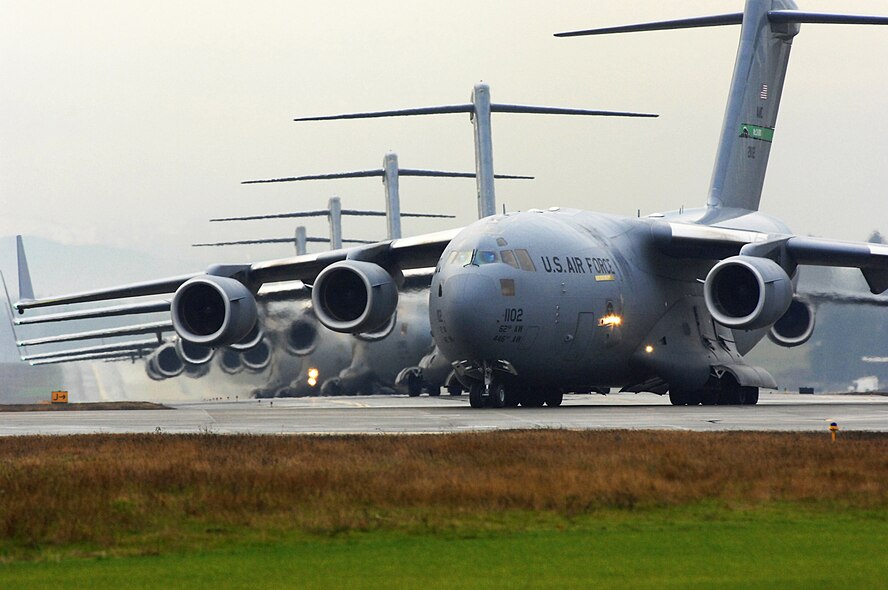 Several C-17 Globemaster III's sit on the flightline prior to being cleared for takeoff as part of a formation training exercise Dec. 20 from McChord Air Force Base, Wash.  The exercise consisted of 10 aircraft and was designed to test all the organizations and different aspects of the mission that have to come together to facilitate launching, executing and recovering a large formation of C-17's in a short period of time. (U.S. Air Force photo/Abner Guzman)