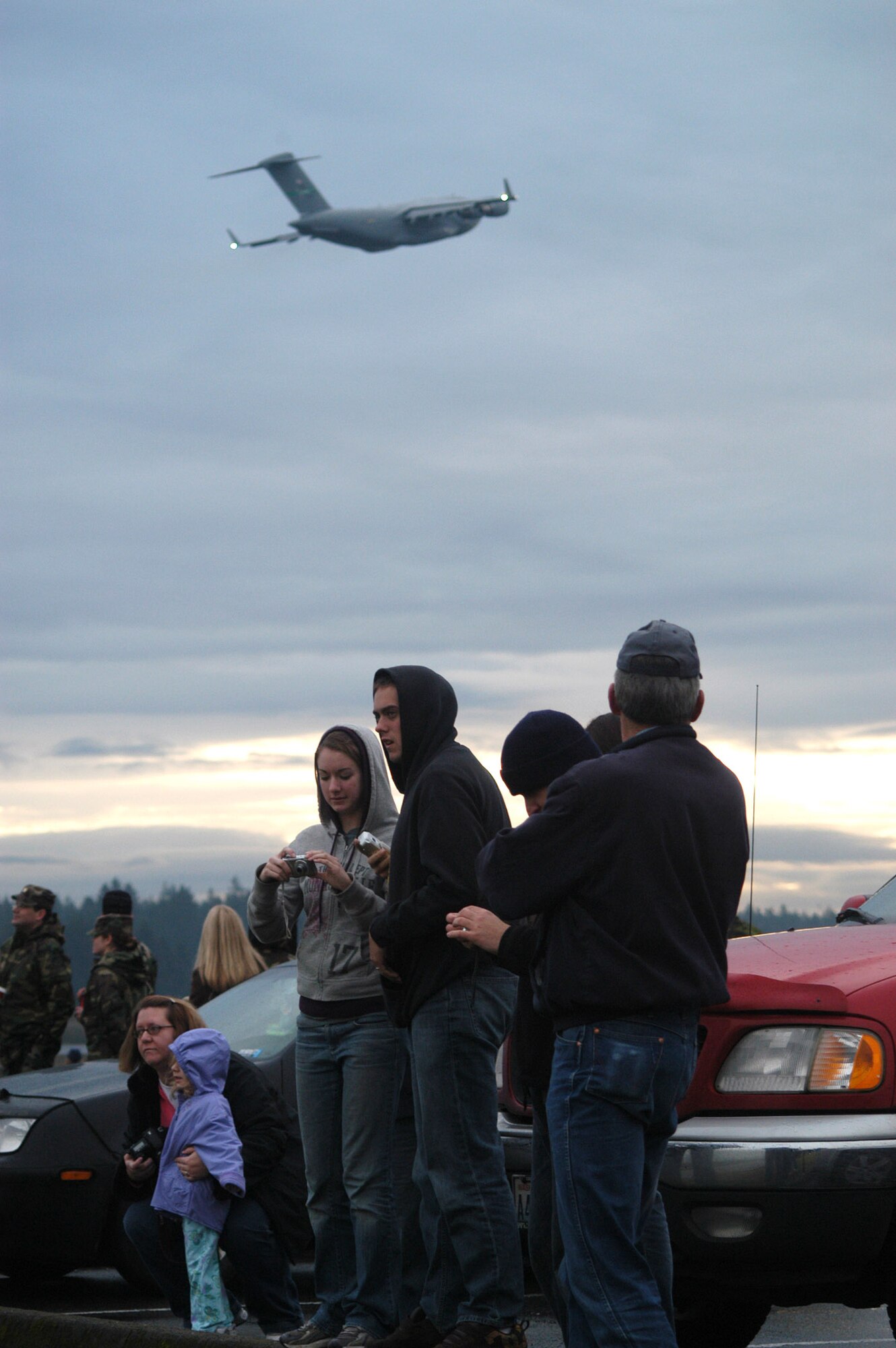 A group of onlookers watch a C-17 Globemaster III formation training excercise Dec. 20 at McChord Air Force Base, Wash.  (U.S. Air Force photo/Adamarie Lewis Page)                  