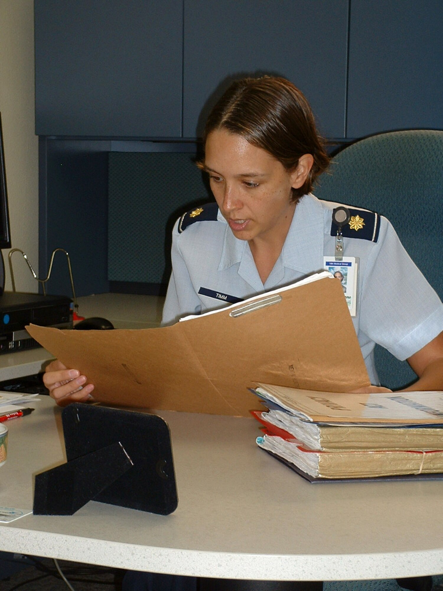 Maj. Samantha Timm looks over a patient record after counseling an Airman Dec. 20 at Kadena Air Base, Japan. As the New Year approaches, she sees a rise in Airmen coming to life skills during the holiday season (U.S. Air Force photo/Staff Sgt. Kevin Nichols)
