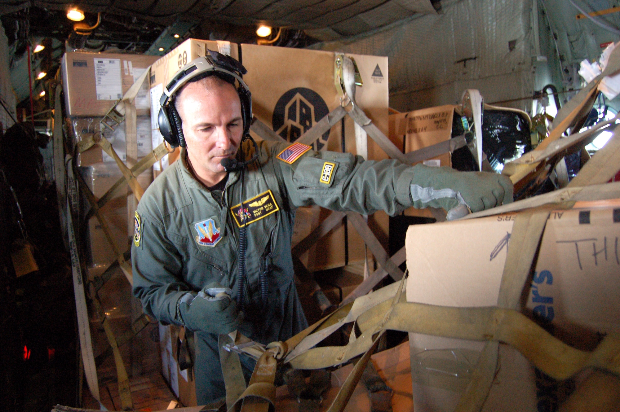 Staff Sgt. Victor Vega checks the netting on a cargo pallet aboard a C-130 Hercules bound for Forward Operating Location Manta, Ecuador, Dec. 12. The loadmaster was one of the first members of the 156th Airlift Wing to deploy their cargo planes to Afghanistan. (U.S. Air Force photo/Louis A. Arana-Barradas)