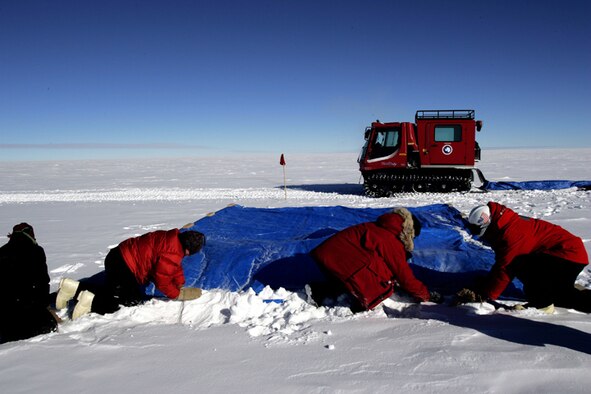 Members of the National Science Foundation wintering in the Antarctic prepare the drop zone for a C-17 Globemaster III that will be airdropping supplies Dec. 20.  Airmen from the 62nd and 446th Airlift Wings at McChord Air Force Base, Wash., delivered 70 tons of supplies to the team. The mission was a "proof of concept" flight for the C-17 and was part of Joint Task Force-Support Forces Antarctica's Operation Deep Freeze.  (U.S. Air Force photo/Lt. Col. James McGann)
