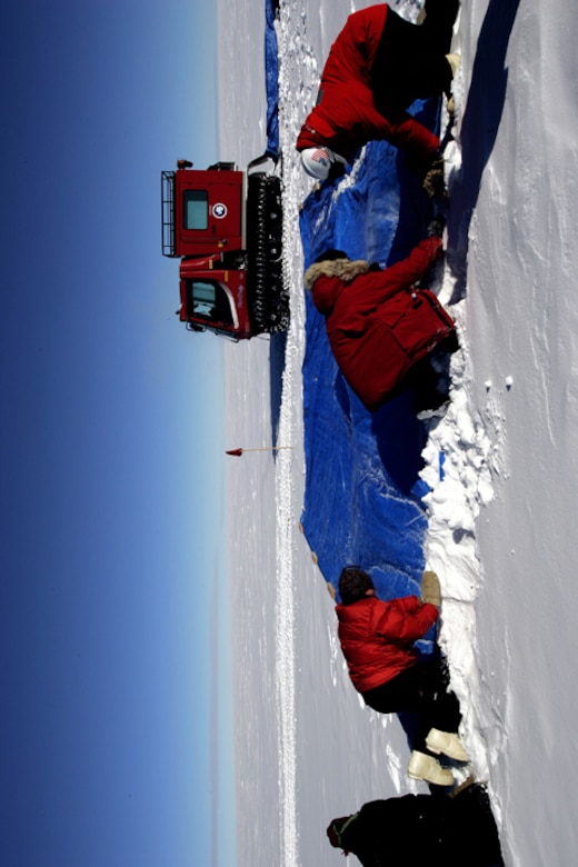 Members of the National Science Foundation wintering in the Antarctic prepare the drop zone for a C-17 Globemaster III that will be airdropping supplies Dec. 20.  Airmen from the 62nd and 446th Airlift Wings at McChord Air Force Base, Wash., delivered 70 tons of supplies to the team. The mission was a "proof of concept" flight for the C-17 and was part of Joint Task Force-Support Forces Antarctica's Operation Deep Freeze.  (U.S. Air Force photo/Lt. Col. James McGann)
