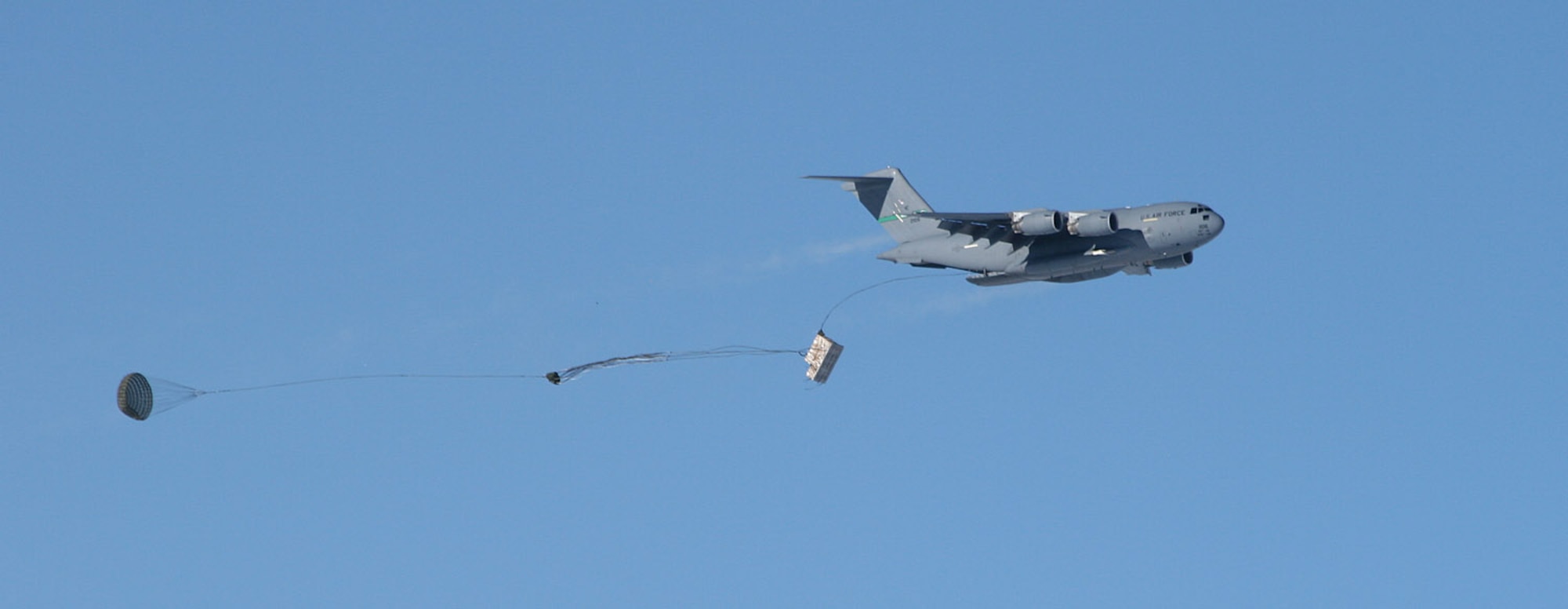 A C-17 Globemaster III drops pallets of cargo Dec. 20 during the first C-17 airdrop to the South Pole.  Airmen from the 62nd and 446th Airlift Wings at McChord Air Force Base, Wash., delivered 70 tons of supplies to the National Science Foundation team wintering there. The mission was a "proof of concept" flight for the C-17 and was part of Joint Task Force-Support Forces Antarctica's Operation Deep Freeze.  (Raytheon Inc. photo/Forest Banks)