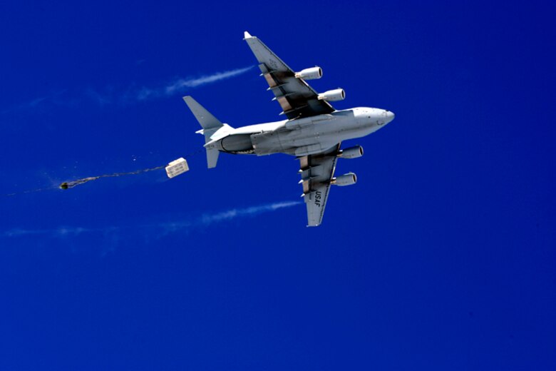 A C-17 Globemaster III drops pallets of cargo Dec. 20 during the first C-17 airdrop to the South Pole.  Airmen from the 62nd and 446th Airlift Wings at McChord Air Force Base, Wash., delivered 70 tons of supplies to the National Science Foundation team wintering there. The mission was a "proof of concept" flight for the C-17 and was part of Joint Task Force-Support Forces Antarctica's Operation Deep Freeze.  (Raytheon Inc. photo/Forest Banks)