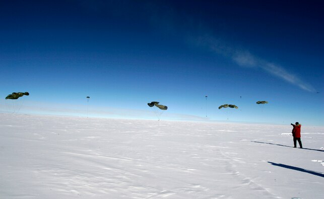 Pallets of cargo fall to the ice Dec. 20 during the first C-17 Globemaster III airdrop to the South Pole.  Airmen from the 62nd and 446th Airlift Wings at McChord Air Force Base, Wash., delivered 70 tons of supplies to the National Science Foundation team wintering there. The mission was a "proof of concept" flight for the C-17 and was part of Joint Task Force-Support Forces Antarctica's Operation Deep Freeze.  (Raytheon Inc. photo/Forest Banks)