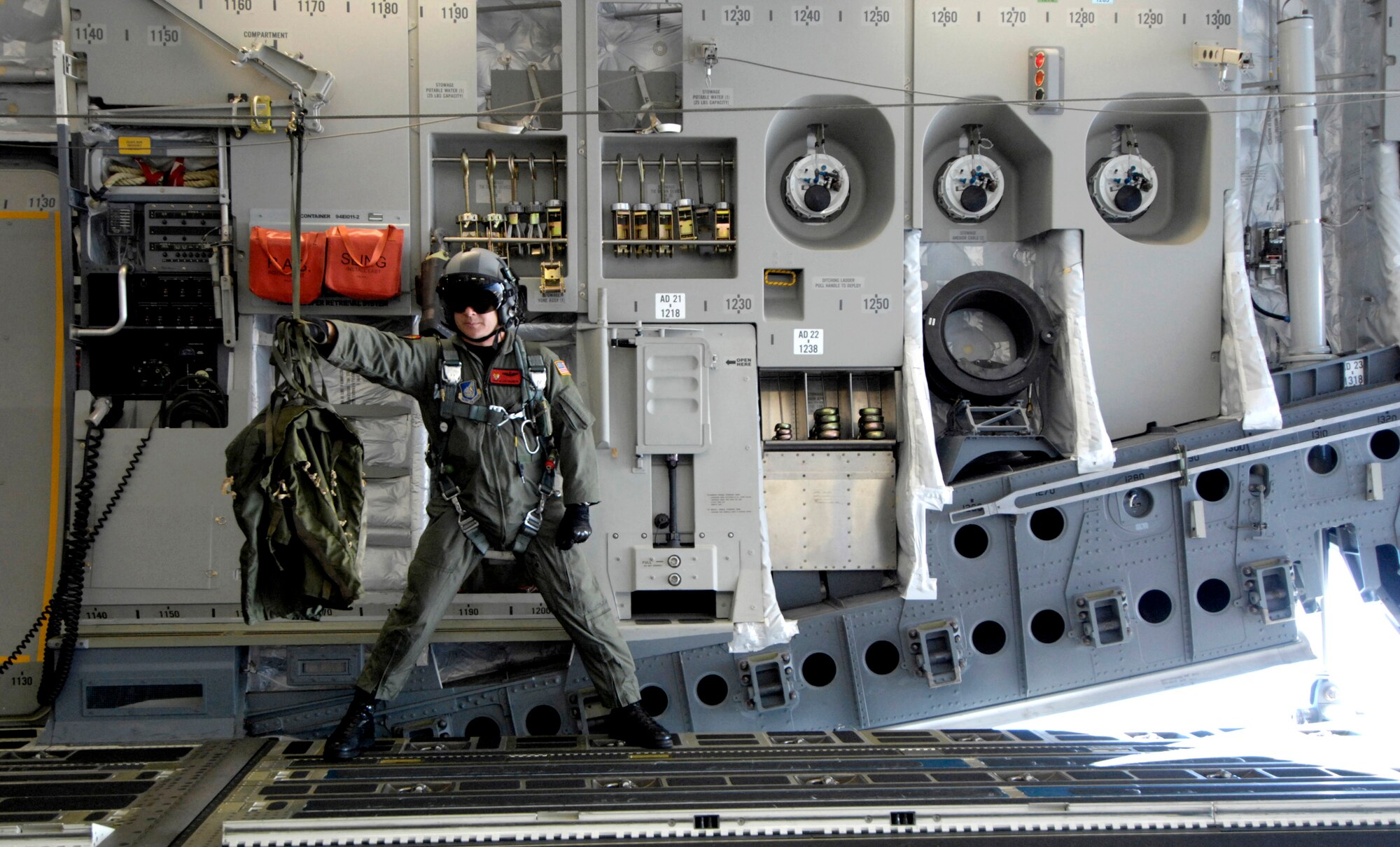 Staff Sgt. Allen Culbreth retrieves static line deployment bags after a container delivery system was released from a C-17 Globemaster III during an airdrop mission Dec. 14 over Andersen Air Force Base, Guam. The C-17 from Hickam Air Force Base, Hawaii, is conducting airdrop training at Andersen AFB. The Airmen is a loadmaster with the 535th Airlift Squadron. (U.S. Air Force photo/Tech. Sgt. Shane A. Cuomo) 