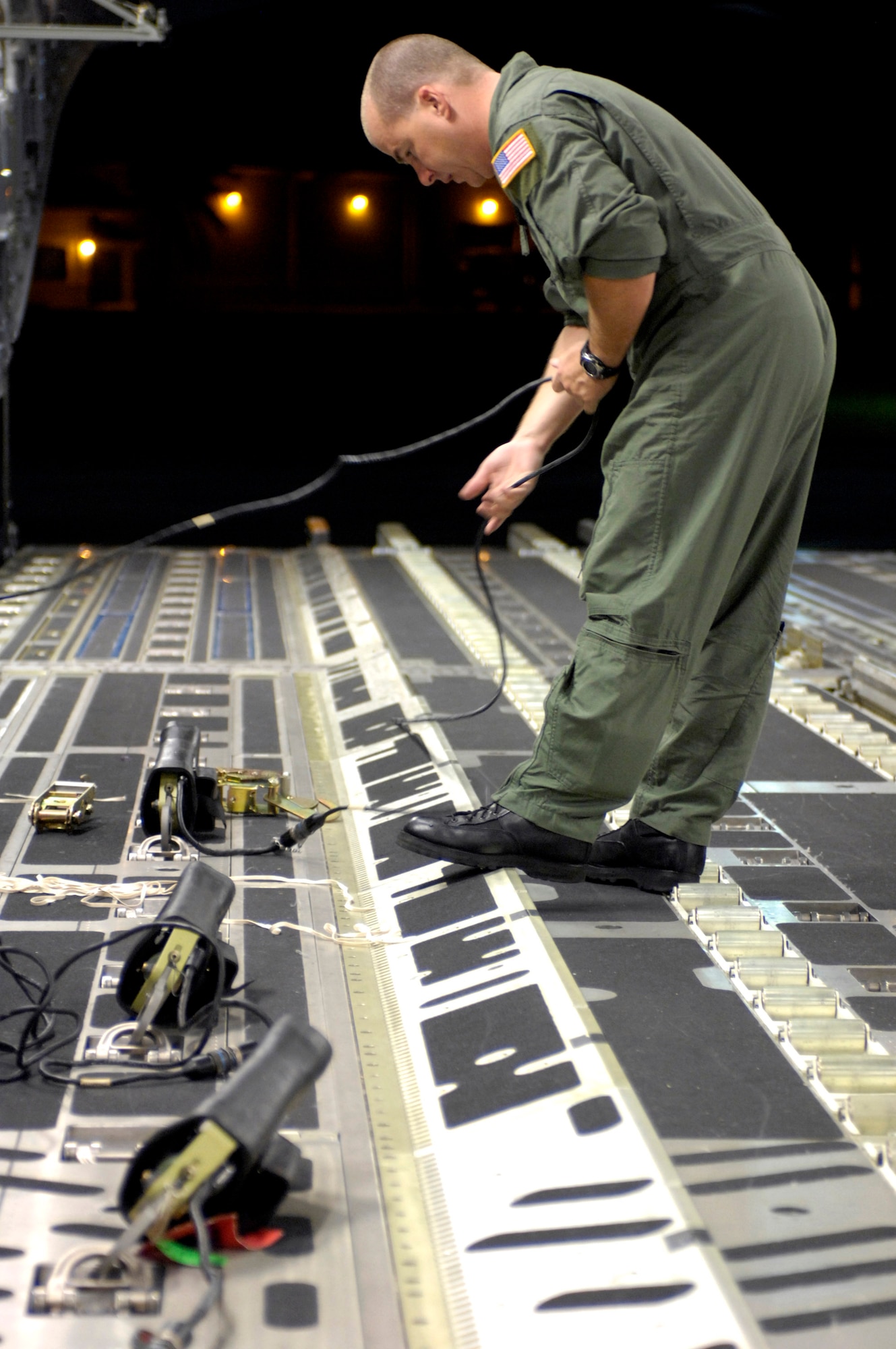 Staff Sgt. Allen Culbreth connects gate release mechanisms on a C-17 Globemaster III for an upcoming airdrop Dec. 14 at Andersen Air Force Base, Guam. The C-17 from Hickam Air Force Base, Hawaii, is conducting airdrop training at Andersen AFB. Sergeant Allen is a loadmaster with the 535th Airlift Squadron. (U.S. Air Force photo/Tech. Sgt. Shane A. Cuomo) 
