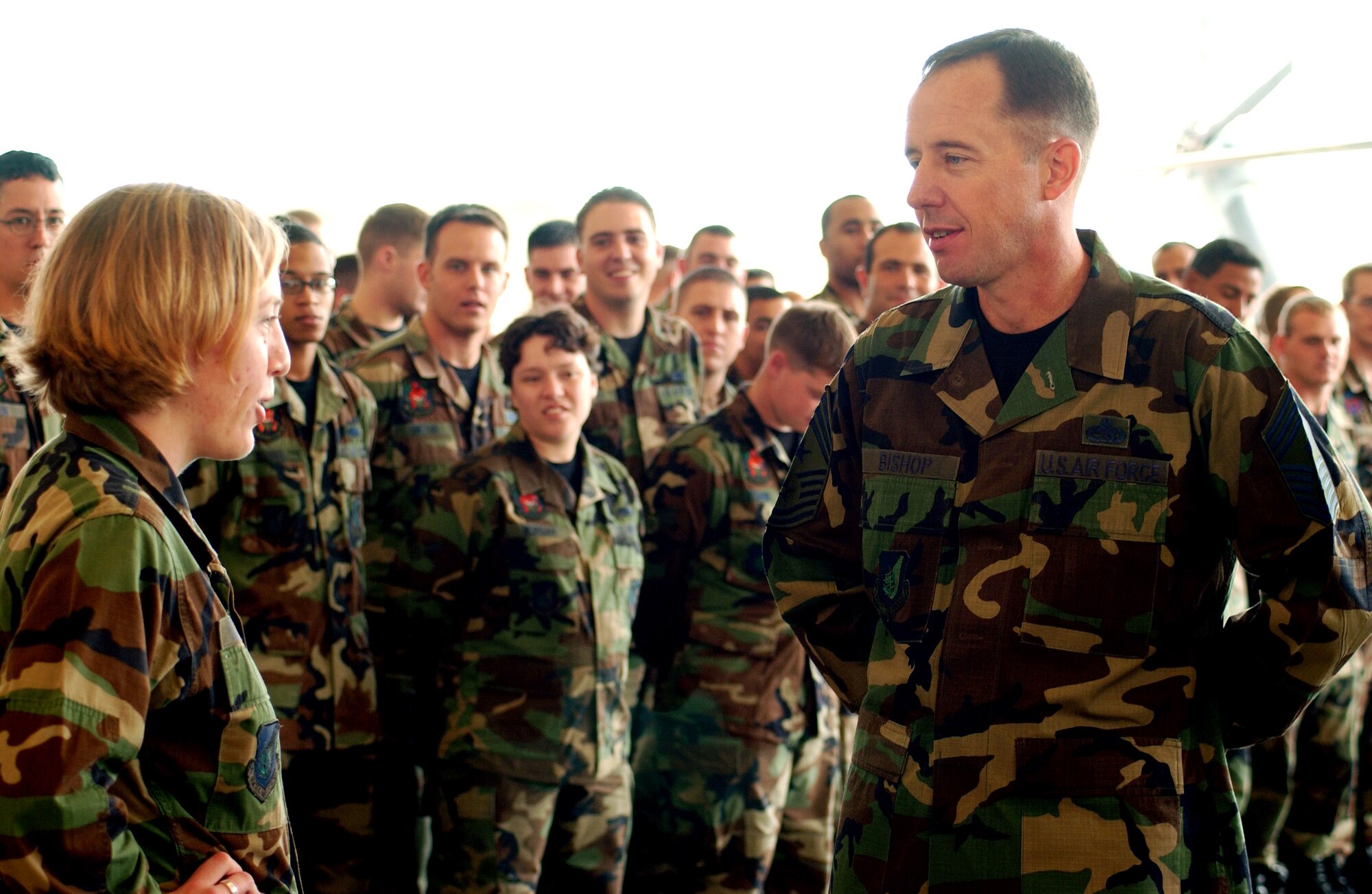 Chief Anthony Bishop asks 2nd Lt. Lauren Calhoun why she joined the Air Force Dec. 19 at Kadena Air Base, Japan. The lieutenant said "to give back." Chief Bishop is the command chief Master sergeant for Pacific Air Forces and visited Airmen throughout Kadena AB. Lieutenant Calhoun is assigned to the 18th Component Maintenance Squadron. (U.S. Air Force photo/Airman 1st Class Kelly Timney)