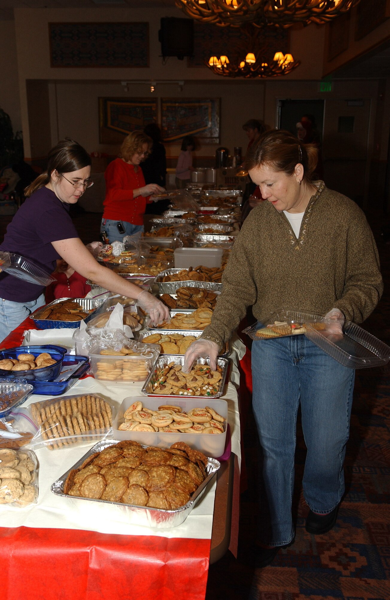 EIELSON AIR FORCE BASE, Alaska -- Jenny Wieland wife of MSgt. Rob Wieland packs cookies in annual Operation Cookie Crunch on Dec. 15. Hundreds of dozens of cookies are packaged up each year and delivered to families of deployed airmen and single airmen stationed on Eielson AFB. The event is not unique to Eielson, but more of an Air Force tradition. 
(U.S. Air Force Photo by Senior Airman Anthony Nelson Jr)