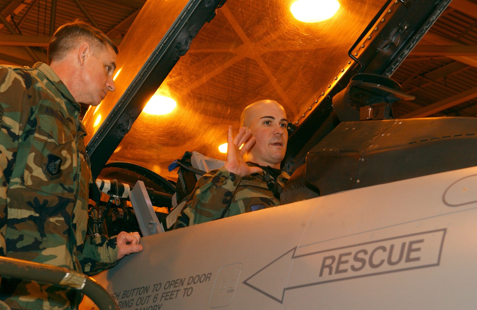 EIELSON AIR FORCE BASE, Alaska -- Technical Sergeant Peter Herbert, 354 AMXS/MXAFS, shows 11th Air Force Command Chief Master Sgt. David Andrews an F-16 cockpit on Dec 19. While visiting Eielson, Chief Andrews stopped by the 18th Aircraft Maintenance Unit for a tour of the building and an exclusive look at an F-16. 
(U.S. Air Force photo by Airman Christopher Griffin.)