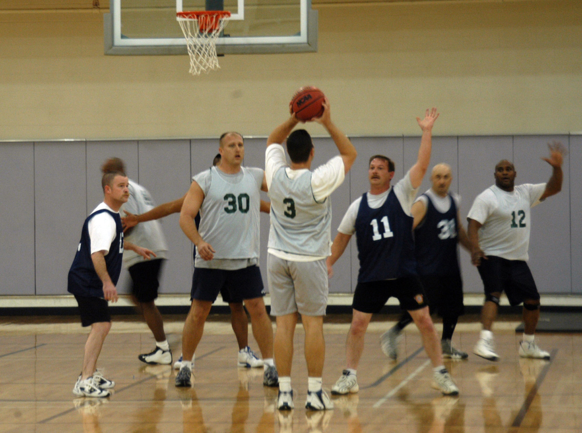 The 7th Civil Engineer Squadron/Fire Department defends their lead in the second half of over-30 basketball Tuesday, allowing them to defeat the 7th Equipment Maintenance Squadron 39-32. (U.S. Air Force photo/Airman 1st Class Carolyn Viss)     