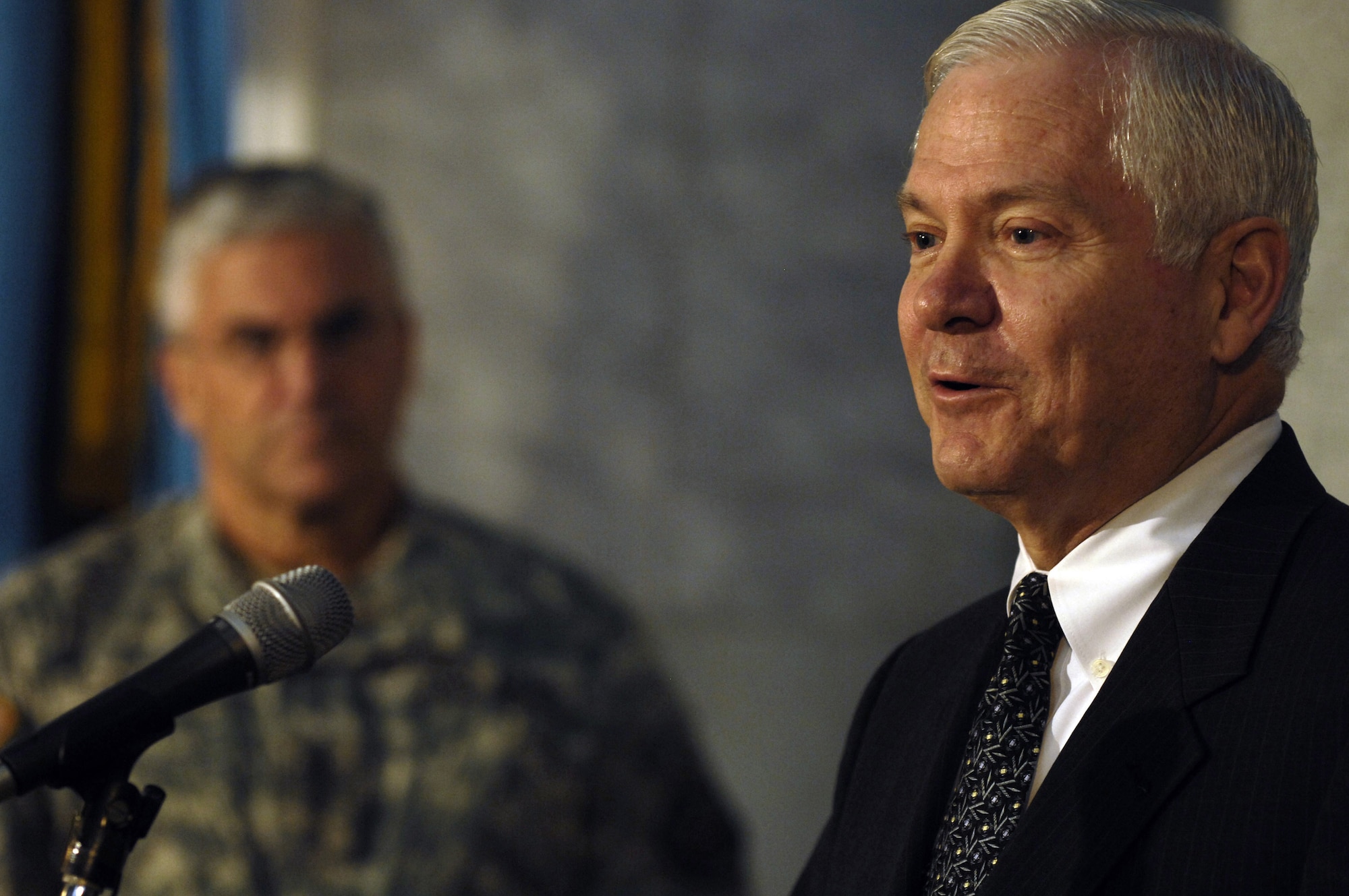 Secretary of Defense Robert M. Gates conducts a press conference as U.S. Army Gen. George W. Casey Jr., commander of Multi-National Force - Iraq, looks on in Baghdad, Iraq, Dec. 20, following a meeting with top generals. (DOD photo/Cherie A. Thurlby)