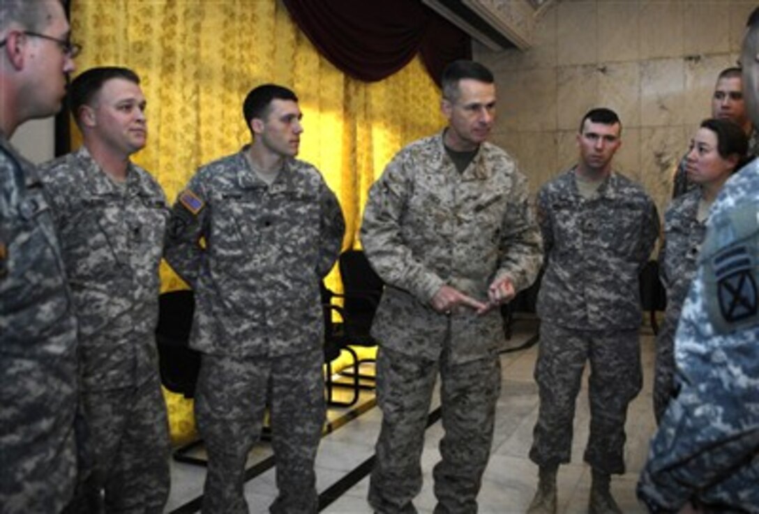 Chairman of the Joint Chiefs of Staff U.S. Marine Gen. Peter Pace speaks with soldiers from the 1st Infantry Division after having a breakfast meeting with them and Defense Secretary Robert Gates at Camp Victory, Iraq, Dec. 21, 2006. 