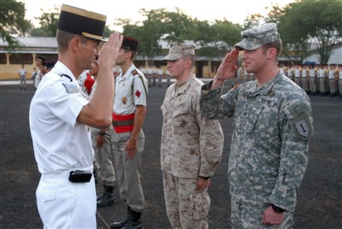 U.S. Army Sgt. Jeremy Verhulst, from Combined Joint Task Force - Horn of Africa, salutes a French officer after graduating from the French Desert Survival Training, organized by the 5th French Marine Regiment, in Djibouti City, Djibouti, Dec. 13, 2006.