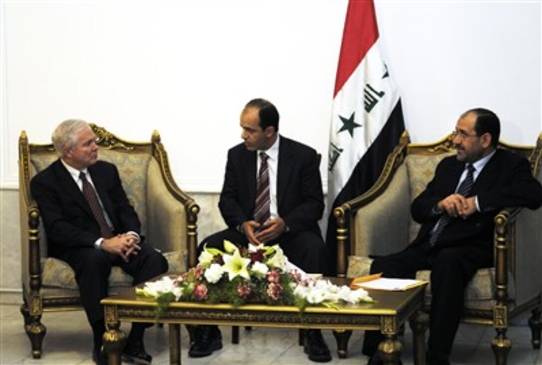 Defense Secretary Robert Gates speaks with Prime Minister Nouri al-Maliki, right, through his interpreter, center, during a meeting in Baghdad to discuss the current and future well-being of Iraq, Dec. 21, 2006.  