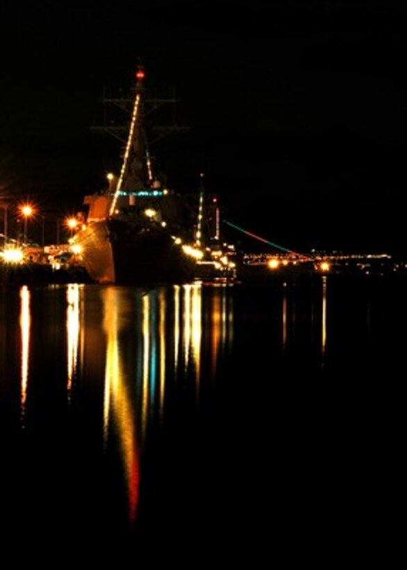 Holiday lights shine from the Arleigh Burke class guided-missile destroyer USS Russell (DDG 59) moored at Naval Station Pearl Harbor, Hawaii, on Dec. 20, 2006. Russell and other ships moored in Pearl Harbor will participate in the 2006 holiday light competition.  