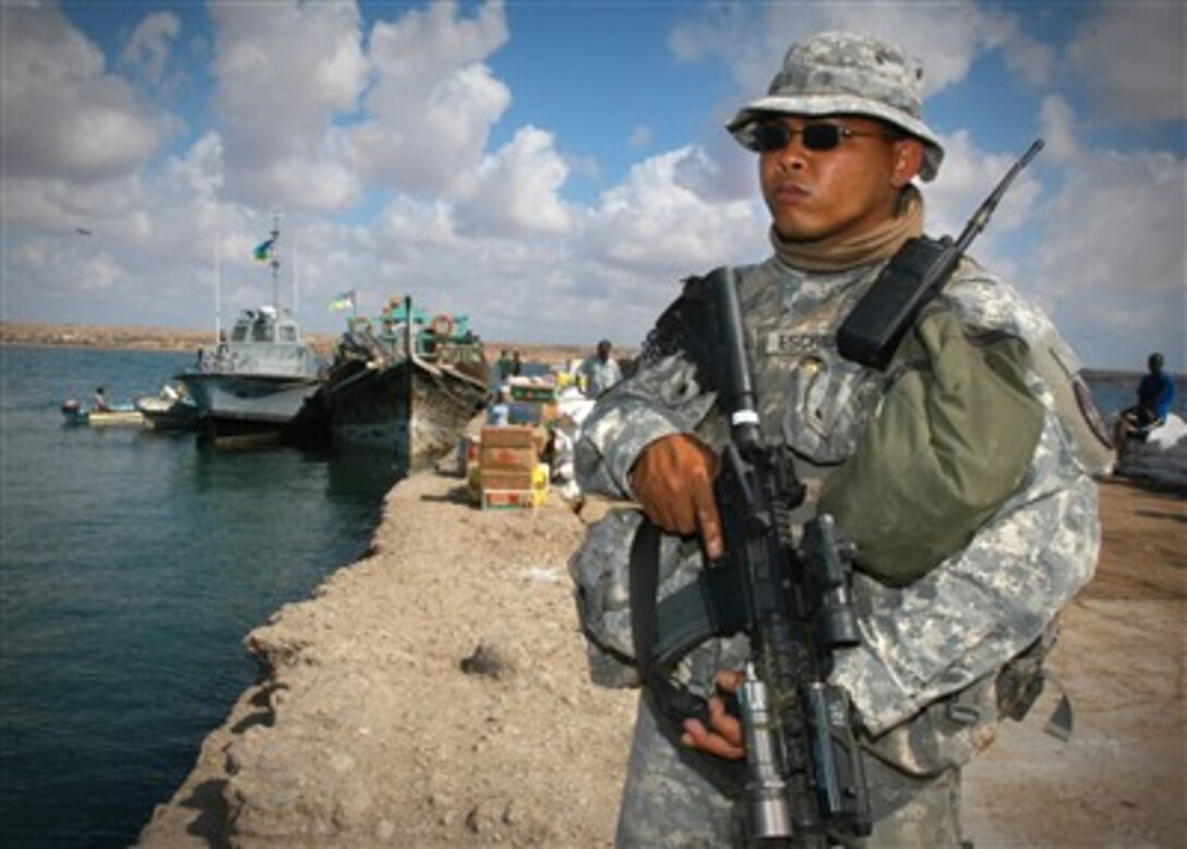 U.S. Army Spc. Phillip Escribano stands perimeter watch at the pier in Obock, Djibouti, on Dec. 9, 2006.  Ray is from the Guam National Guard and attached to Combined Joint Task Force - Horn of Africa.  