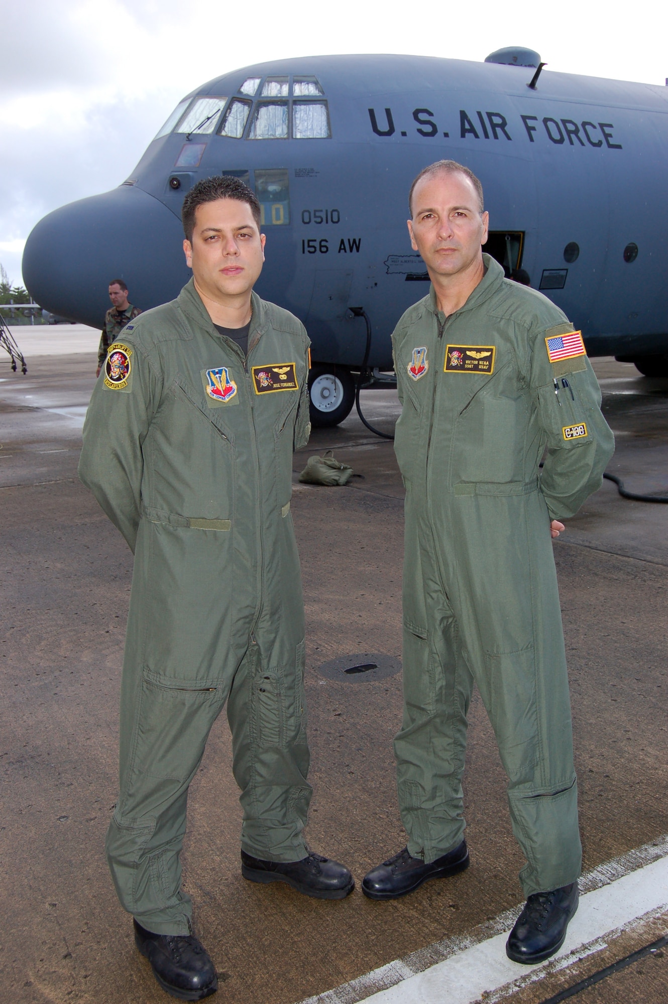 Pilot First Lt. Jose Fernandez (left) and loadmaster Staff Sgt. Victor Vega stand before their C-130 Hercules at Mu?iz Air National Guard Base, Puerto Rico, Dec. 15. The Airmen had just returned home after a four-country mission to Central and South American and the Caribbean. The two were also among the first members of the 156th Airlift Wing to deploy their cargo planes to Afghanistan. (U.S. Air Force photo/Louis A. Arana-Barradas)