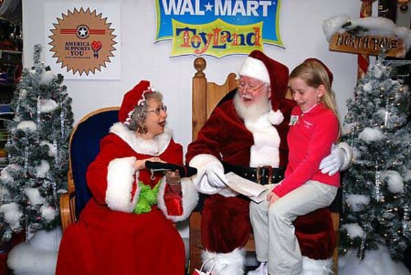 Santa and Mrs. Claus open their gift from Sydney Spillane, 8, daughter of Senior Master Sgt. John Spillane, 29th Weapons School superintendent, during her trip to North Pole, Alaska, recently. Sydney and her parents, Tanya and Sergeant Spillane, won a trip to Santa's workshop and the first-ever "Top of the World Toy Summit" to test this year's hottest toys and visit with Santa. (Photo by Tanya Spillane)
