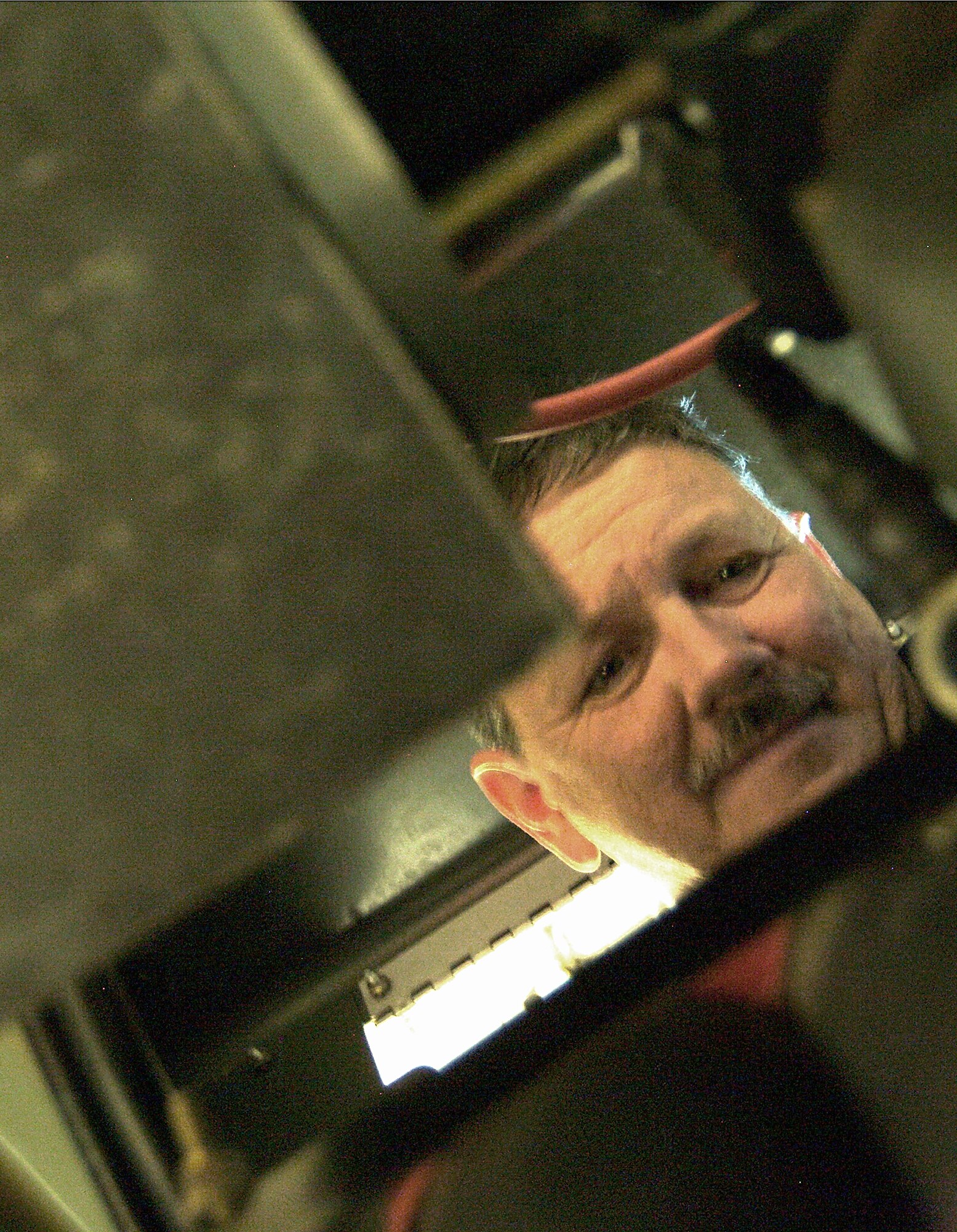 WHITEMAN AFB, Mo. -- Air Force reservist Tech. Sgt. Tony Johnson, a 442nd Maintenance Squadron Aerospace Ground Equipment technician, here, peers into the inner workings of a light-all as he works to repair it. US Air Force photo / Master Sgt. Bill Huntington