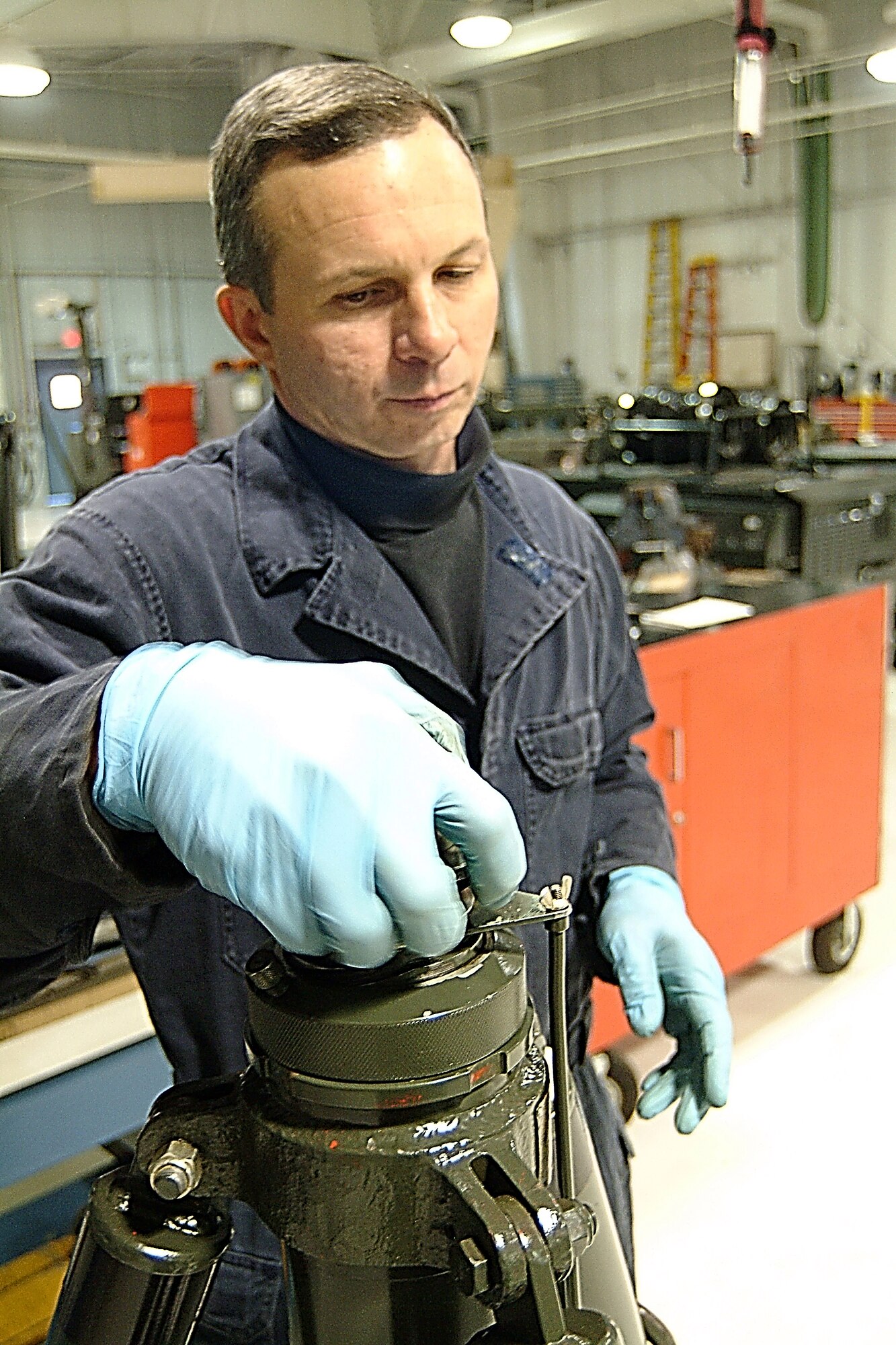 WHITEMAN AFB, Mo. -- Tech. Sgt. Leroy Sharbono, a 442nd Maintenance Squadron Aerospace Ground Equipment technician and an Air Force reservist, here, works on an aircraft jack stand, one of the many types of equipment the AGE shop is responsible for maintaining. US Air Force photo / Master Sgt. Bill Huntington