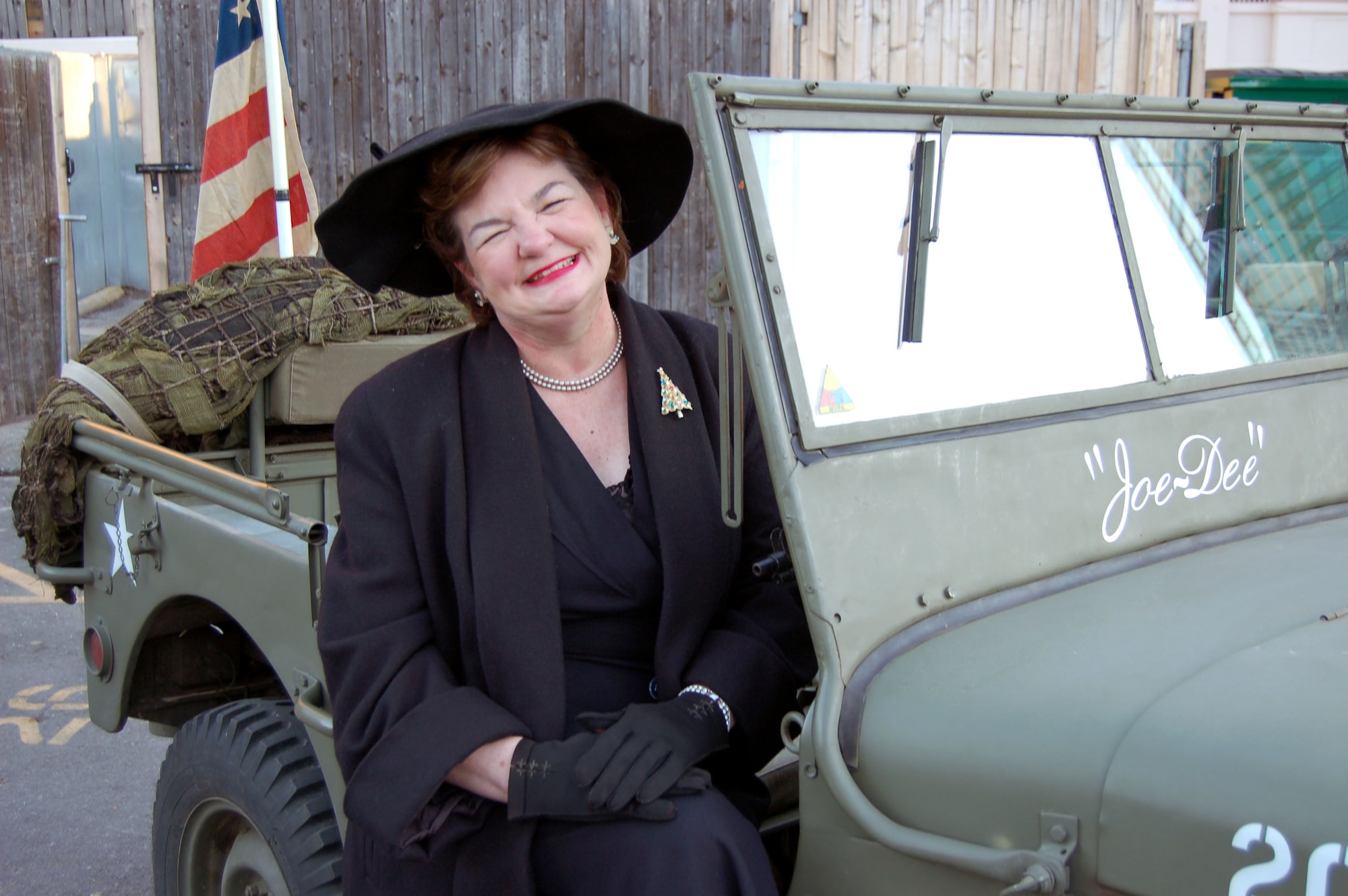 Dee Bash sits in an authentic World War II jeep on display at the Bell Helicopter Armed Forces Bowl Pep Rally at Sundance Square in Fort Worth, Texas, Dec. 22. Ms. Bash is with the Military Vehicle Preservation Association, a living history organization. (U.S. Air Force photo/Annette Crawford)