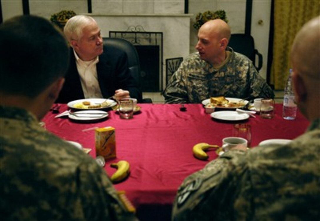 Defense Secretary Robert Gates listens as U.S. Army and Marine trainers embedded with Iraqi units discuss the progress of Iraqi trainees during a breakfast meeting at the Joint Visitors Bureau, in Baghdad, Iraq, Dec. 22, 2006. 