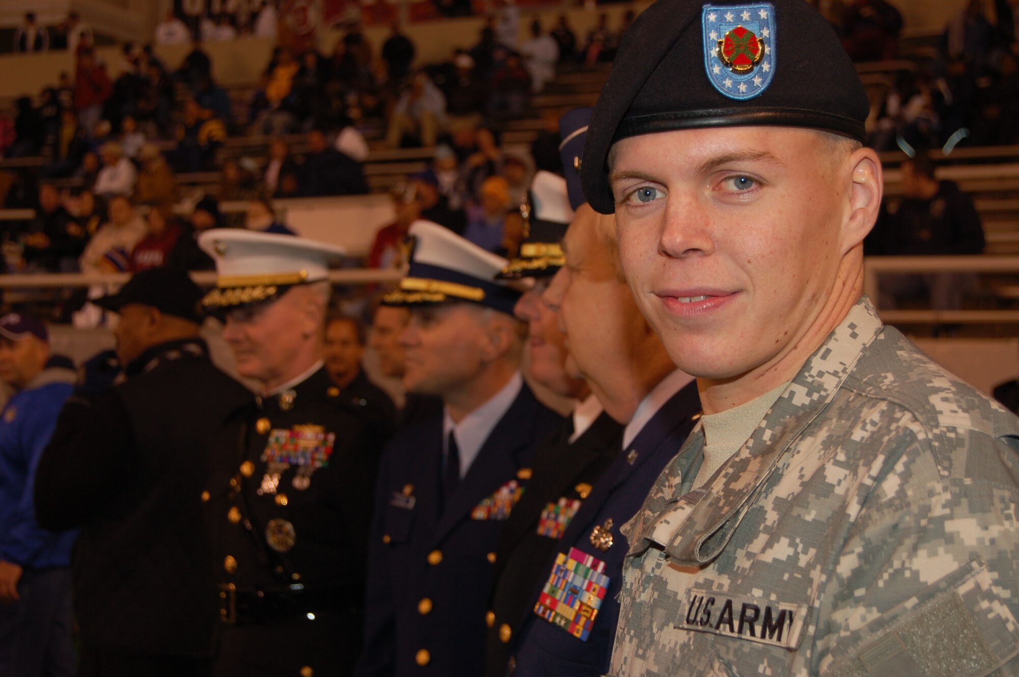 The junior-ranking military member of the Bell Helicopter Armed Forces Bowl Coin Toss Ceremony, Private 1st Class Dennis Bowsher, stands in line with other ceremony officials before the start of the game. Private Bowsher is the 2005 National Pentathlete Champion and member of the Army World Class Athlete Program. He is a potential 2008 Olympic participant, and is a native of the Dallas-Fort Worth area. (U.S. Air Force photo/Annette Crawford)