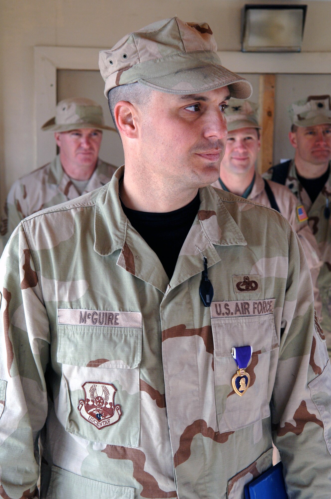 Senior Master Sgt. Daniel McGuire was awarded a Purple Heart medal by Brig. Gen. Christopher Miller, 455th Air Expeditionary Wing commander, Dec. 23. The medal was awarded for injuries sustained by enemy action on a convoy mission outside of Kandahar Airfield along with two U.S. Army soldiers.  Sgt. McGuire is deployed to the theater from MacDill Air Force Base where he is the Vehicle Operations Manager. (U.S. Air Force photo/Tech. Sgt. Joseph Kapinos)
