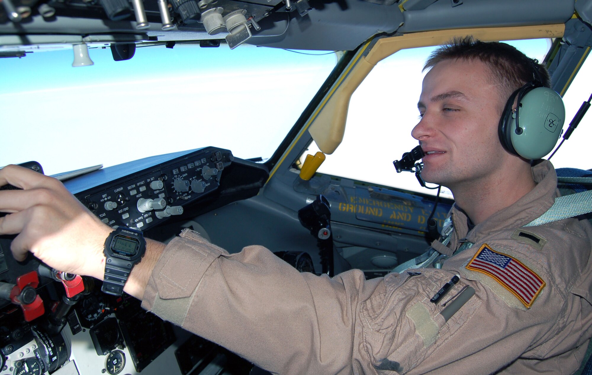 1st Lt. Tyler West, flying a KC-135 Stratotanker, makes in-flight adjustments during an aerial refueling mission Christmas Day.  "(Us being here) tells the enemy we have complete resolve and we believe in what we are doing and we're going to be here regardless of Christmas or not," he said. Lieutenant West is a 22nd Expeditionary Air Refueling Squadron pilot deployed to Manas Air Base, Kyrgyzstan, from the 93 ARS at Fairchild Air Force Base, Wash. (U.S. Air Force photo/Master Sgt. Mitch Gettle)