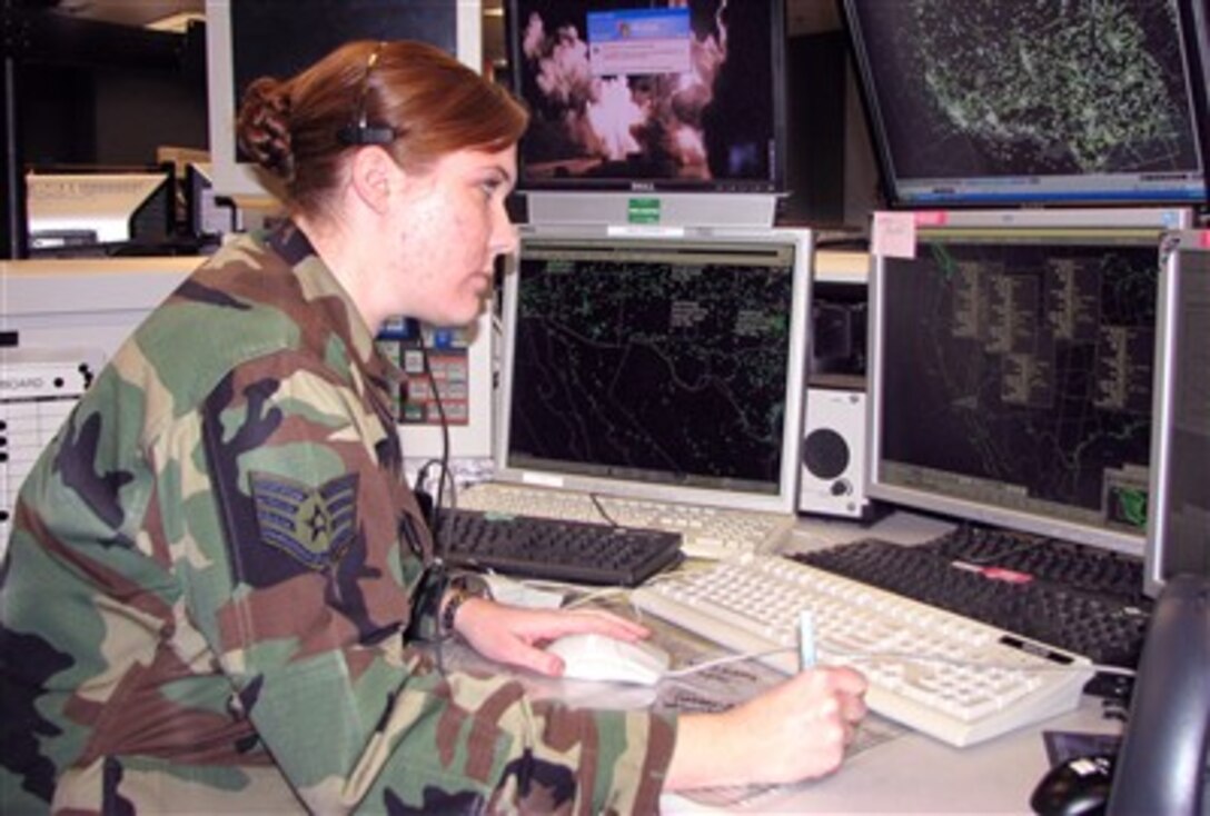 U.S. Air Force Staff Sgt. Lara Koler, a native of Eugene, Ore., tracks targets on her radar screens at the Western Air Defense Sector at McChord Air Force Base, Wash., during this holiday season.