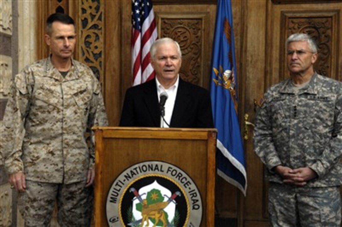 Secretary of Defense Robert M. Gates (center) responds to a reporter's question during a press conference in Baghdad, Iraq, on Dec. 22, 2006.  Gates, along with Chairman of the Joint Chiefs of Staff Gen. Peter Pace (left), U.S. Marine Corps, is in Iraq to meet with Iraqi leaders, Army Gen. George Casey (right), commander Multinational Forces-Iraq, and Army Gen. John Abizaid (not shown), commander of U.S. Central Command, to discuss the way ahead in Iraq.  