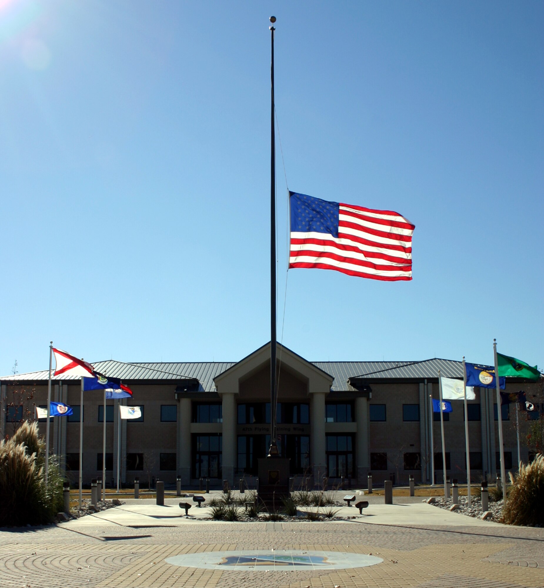 Blowing in the breeze, the flag outside the 47th Flying Training Wing headquarters hangs at half-staff in remembrance of President Gerald R. Ford, the thirty-eighth president of the United States. (U.S. Air Force photo by 2nd Lt. Courtney Kippenberger) 