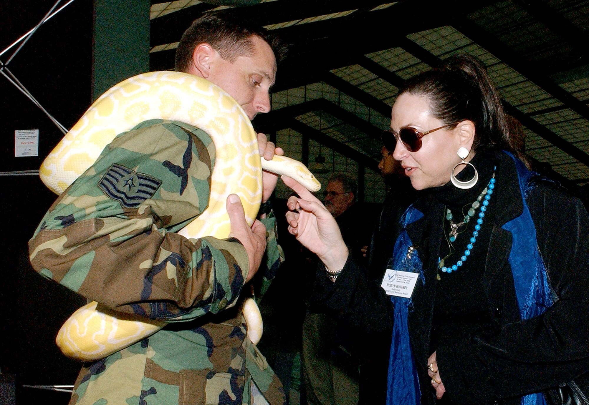 Robyn Whitney gets an up-close look at an albino boa constrictor used by the Survival, Evasion, Resistance, Escape Course trainers at Lackland Air Force Base, Texas, during a National Civic Outreach Program tour. (U.S. Air Force photo/Alan Boedecker)
