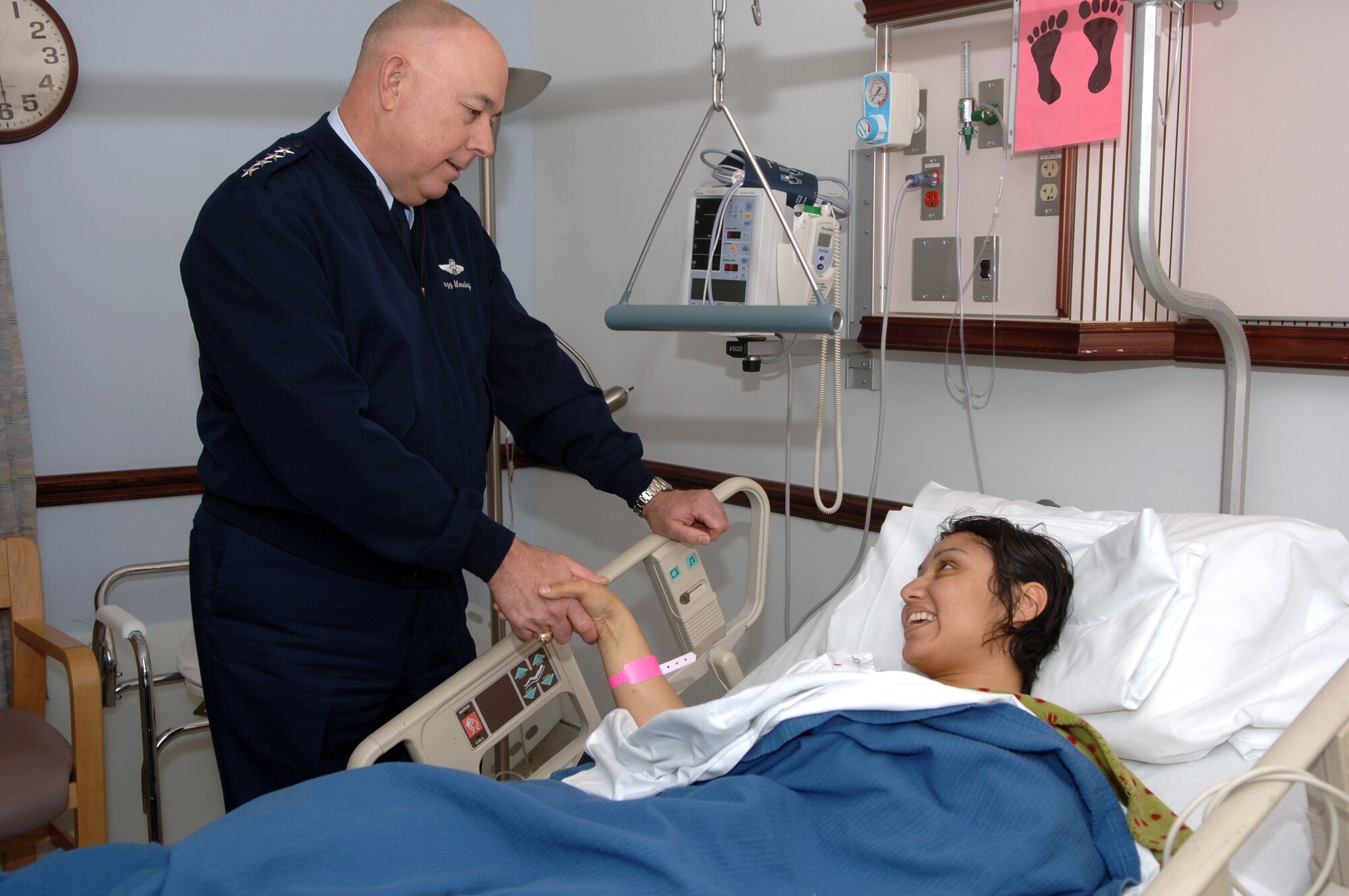 Air Force Chief of Staff T. Michael Moseley offers his best wishes to Staff Sgt. Aime Gaona Dec. 27 during a visit to Malcolm Grow Medical Center at Andrews Air Force Base, Md.  Sergeant Gaona was wounded while deployed to Iraq from Luke AFB, Ariz.  She arrived at Malcolm Grow Dec. 22 after being shot in the right thigh by a sniper just four days earlier. (U.S. Air Force photo/Tech. Sgt. Christopher J. Matthews)