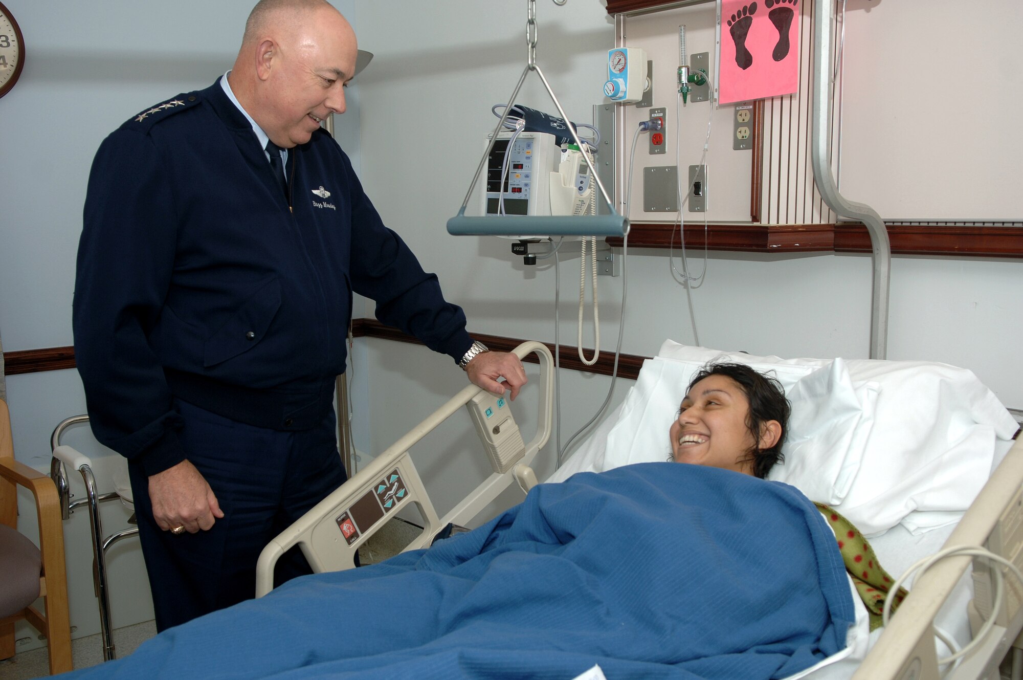 Air Force Chief of Staff T. Michael Moseley visits with Staff Sgt. Aime Gaona Dec. 27 at Malcolm Grow Medical Center on Andrews Air Force Base, Md.  Sergeant Gaona was wounded while deployed to Iraq from Luke AFB, Ariz.  She arrived at Malcolm Grow Dec. 22 after being shot in the right thigh by a sniper just four days earlier. (U.S. Air Force photo/Tech. Sgt. Christopher J. Matthews)