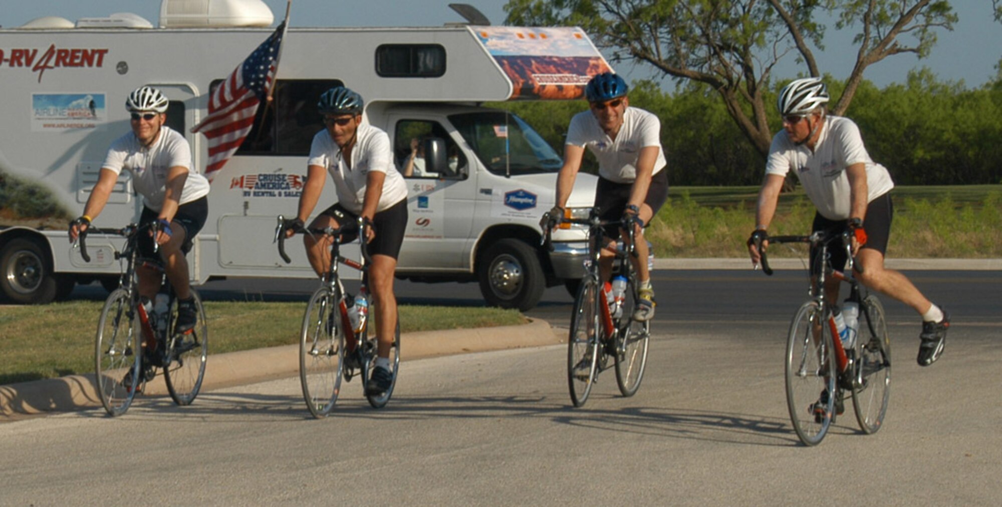 (From left): Major Mark Clark, an air liaison officer based out of Denver, Colo., along with Robert McGee, Paul Guttenberg, and TomHeidenberger, arrive at Dyess Wednesday evening after riding from Midland, Texas. The team is riding approximately 100 miles per day across the United States in honor of the crewmembers who died on four flights September 11, 2001. They are riding from Los Angeles to Washington, D.C. They began their journey April 2 and plan to arrive at the Pentagon May 9 at 1:30 p.m. Their ambitious 33-day trek dedicates one day to each of the crewmembers who died that day.
