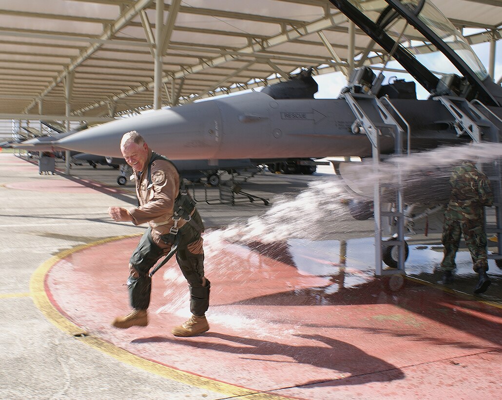 General Twitchell doesn’t make it easy for the 93rd Fighter Squadron pilots as they attempt the traditional “hose down” following his final flight Dec. 19.   General Twitchell was the 482nd FW Vice Commander from 1990-92 at Homestead Air Reserve Base, Fla. (Air Force photo/Ryan Ayers)