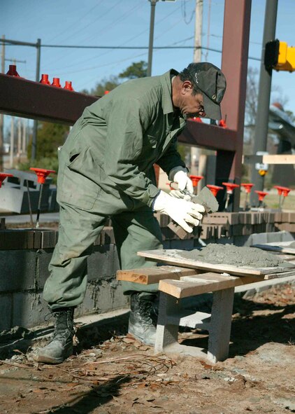SHAW AIR FORCE BASE, S.C.-- Edgar Cliett, 20th Civil Engineer Squadron, builds a brick facade Dec. 27 to the new base marquee at the Rhodes Avenue and Shaw Drive intersection. The new 8-by-15 foot marquee will display current sortie numbers in addition to base announcements.  (U.S. Air Force photo/Senior Airman John Gordinier) 