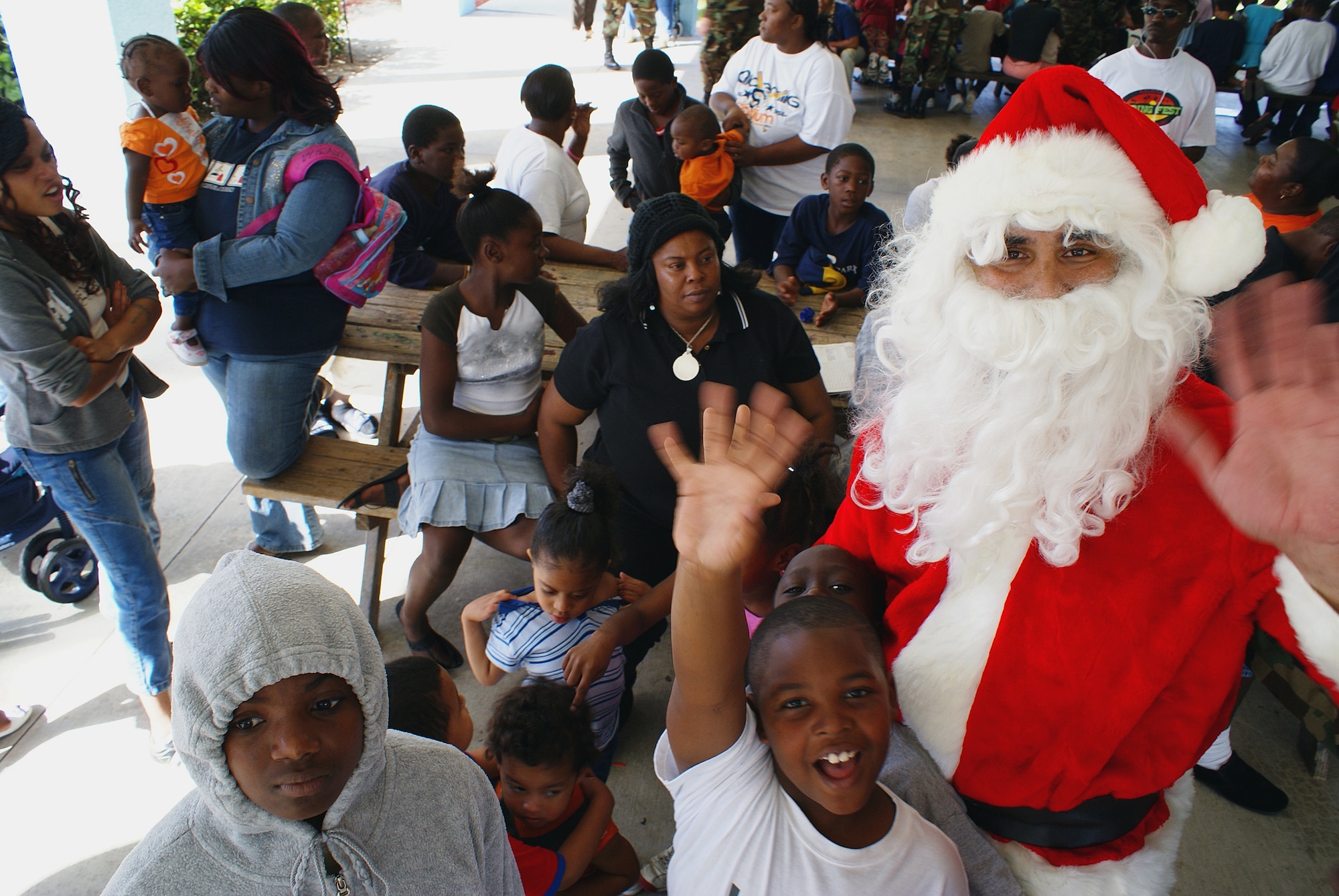 An unidentified Air Force reservist playing Santa arrived in style on his “sleigh” to meet the children at Community Partnership for Homeless Dec. 3 thanks to the help of the base fire department. Kids and adults alike jumped at the chance to give him their wish lists. The event was part of a community outreach program sponsored by the Homestead Air Reserve Base Junior Enlisted Council.  (Air Force photo/Dan Galindo)