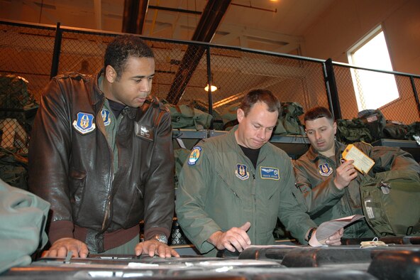 YOUNGSTOWN AIR RESERVE STATION, Ohio -- Air Force Reservists Master Sgt. Drew Harris, loadmaster, 1st Lt. Travis Adams, pilot, and 1st Lt. Anthony Santucci, pilot, all assigned to the 757th Airlift Squadron here, inspect their mobility equipment in preparation for an upcoming deployment exercise.  The 757th is one of two flying squadrons assigned to the 910th Airlift Wing with the other being the 773rd Airlift Squadron.  Men and women assigned to the 757th also conduct the unique aerial spray mission for the Air Force Reserve.  U.S. Air Force photo/Senior Airman Ann W. Jefferson.