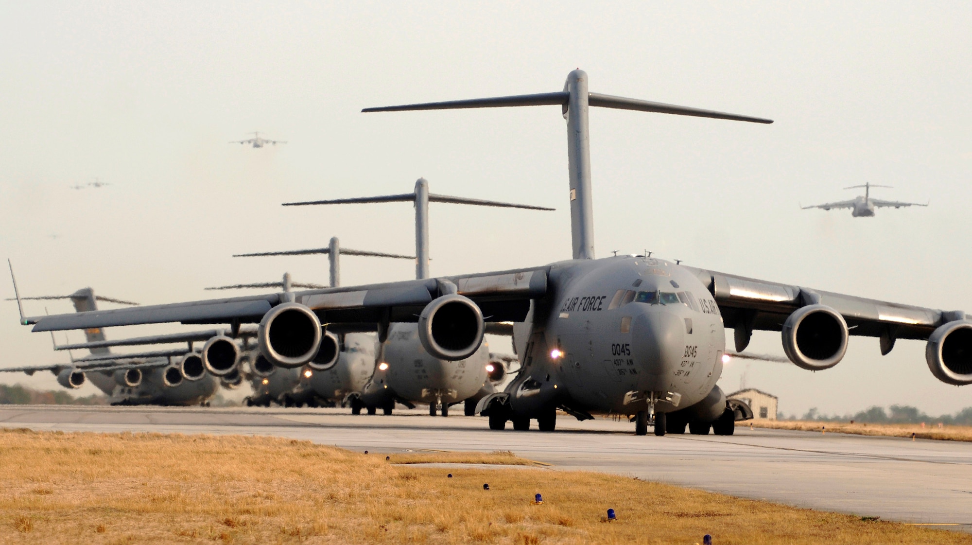 C-17 Globemaster III's prepare for takeoff Dec. 21 at Charleston Air Force Base, S.C. The C-17 is capable of rapid, strategic delivery of troops and all types of cargo. The design of the aircraft allows it to operate on small, austere airfields. It can take off and land on runways as short as 3,500 feet and 90 feet wide. (U.S. Air Force photo/Staff Sgt. Marie Cassetty)   