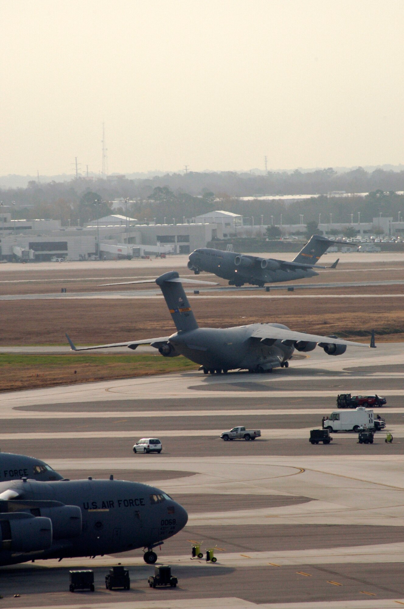 C-17 Globemaster III's prepare for takeoff Dec. 21 at Charleston Air Force Base, S.C. The C-17 is capable of rapid, strategic delivery of troops and all types of cargo. The design of the aircraft allows it to operate on small, austere airfields. It can take off and land on runways as short as 3,500 feet and 90 feet wide. (U.S. Air Force photo/Staff Sgt. April Quintanilla) 